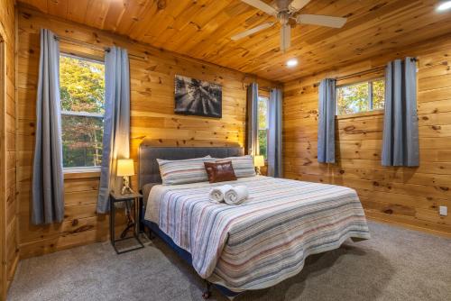 a bedroom with a bed in a log cabin at New listing-- Hocking Hills Modern Cabin in Logan