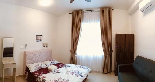a small bedroom with a bed and a window at Mesahill Home Stay Nilai in Nilai