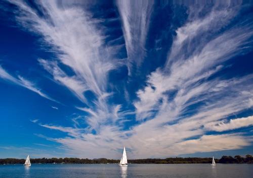 a group of sailboats on the water under a blue sky at Ana Mandara Luxury Retreat in Port Macquarie