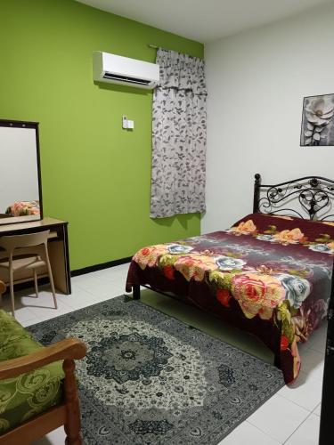 a bedroom with a bed and a mirror at ROSSA Condo 1 in Kuah