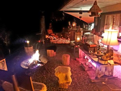 a living room with a fireplace and a fire place at Alp Chnorz Penthouse in Nesslau