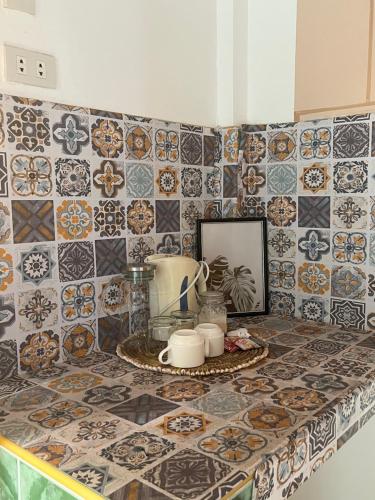a kitchen counter with tiles on the wall at Villa Consolacion Resort in General Luna