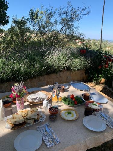 a table with plates of food on top of it at Beit Al Rahi in Ḑahr al Ḩarf