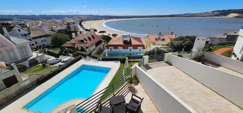 a villa with a swimming pool and a beach at Beach Views-Ocean Breeze-Duplex Dreams in São Martinho do Porto