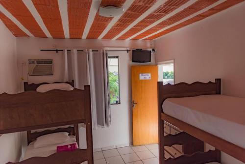 a room with two bunk beds and a window at Pousada ExpoBH in Belo Horizonte
