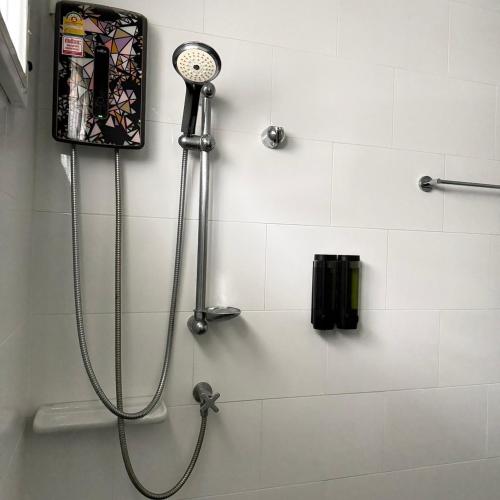 a shower in a bathroom with a shower head at Kitjamyhome2 in Ban Tha Thon
