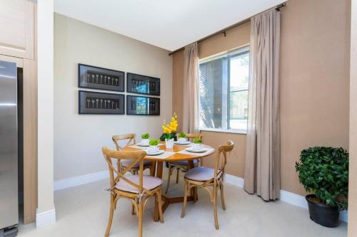 a dining room with a table and chairs and a window at Marvelous 4 Bd Close to Disney @ Magic Village 3153 in Orlando