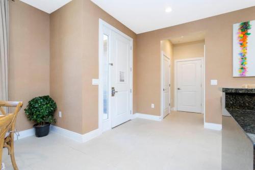 a hallway of a home with a fireplace and a door at Marvelous 4 Bd Close to Disney @ Magic Village 3153 in Orlando