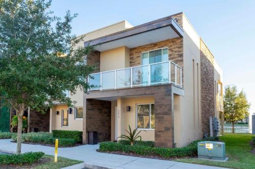a house with a balcony on the side of it at Stunning 4Bd Close to Disney @ Magic Village 7614 in Orlando