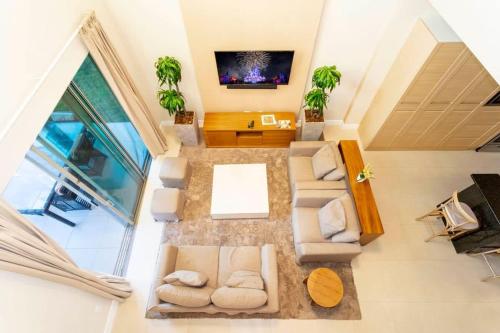 an overhead view of a living room with a tv at Stunning 4Bd Close to Disney @ Magic Village 7614 in Orlando