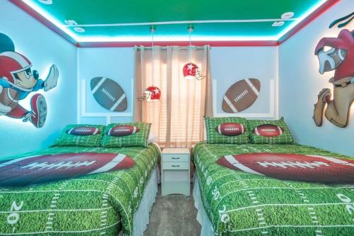 two beds in a room with a football bedroom at Wonderful 5 Bd w Pool @ Storey Lake Resort 2545 in Kissimmee
