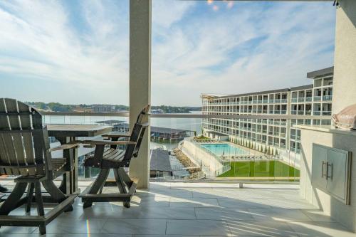 a balcony with a table and chairs and a view of a building at Wow Where Dreams become Reality New Luxury Unit in Osage Beach