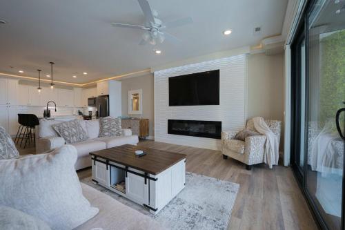 a living room with a couch and a flat screen tv at Wow Where Dreams become Reality New Luxury Unit in Osage Beach