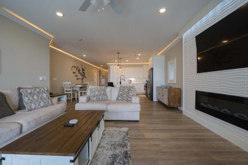 a living room with two couches and a fireplace at Wow Where Dreams become Reality New Luxury Unit in Osage Beach