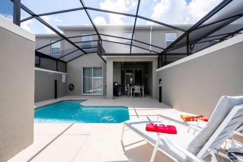 a swimming pool in the backyard of a house at Marvelous 4Bd with Pool at Storey Lake Resort 2601 in Kissimmee