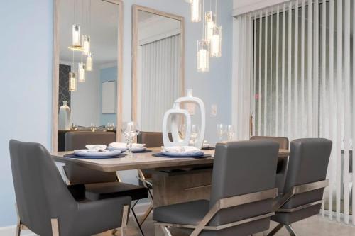 a dining room with a wooden table and chairs at Marvelous 4Bd with Pool at Storey Lake Resort 2601 in Kissimmee