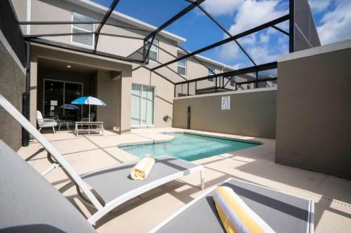 a swimming pool in a house with a glass ceiling at Gorgeous 4 Bedroom w Screened Pool Close to Disney 2653 in Kissimmee