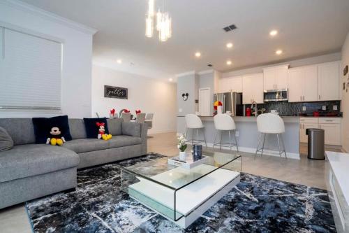 a living room with a couch and a glass table at Gorgeous 4 Bedroom w Screened Pool Close to Disney 2653 in Kissimmee