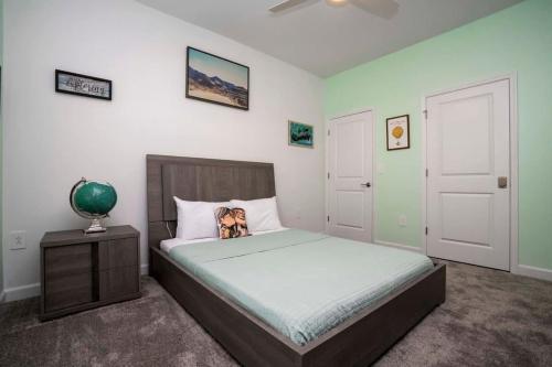 a bedroom with a bed with a dog on the pillow at Gorgeous 4 Bedroom w Screened Pool Close to Disney 2653 in Kissimmee
