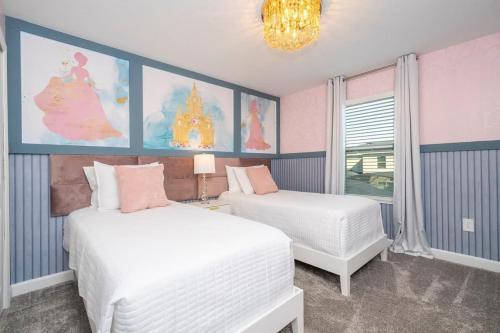 a bedroom with two beds and a chandelier at Charming 4Bd w Private Pool @ Storey Lake Resort 2653 in Kissimmee