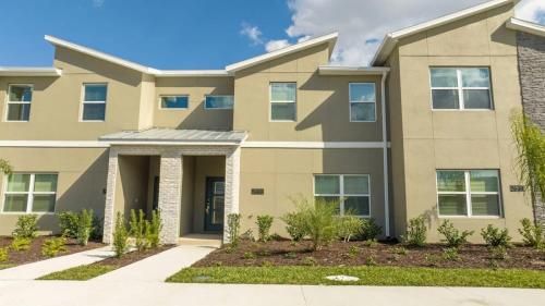 a large apartment building with a driveway at Charming 4Bd w Private Pool @ Storey Lake Resort 2653 in Kissimmee