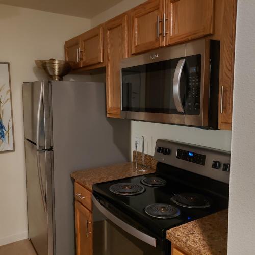 a kitchen with a stove and a microwave at Elegant 2Bed & 2 Bath Comfort in Dallas