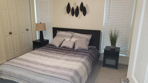 a bedroom with a bed with two pillows on it at Elegant 2Bed & 2 Bath Comfort in Dallas