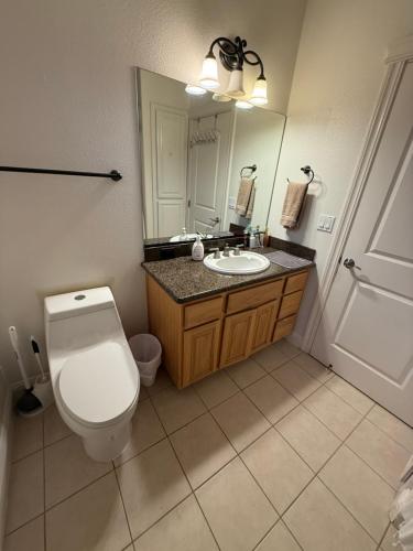 a bathroom with a toilet and a sink and a mirror at The Ark in Redding