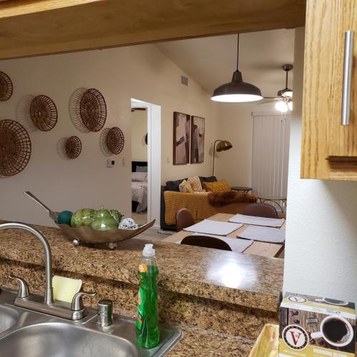 a kitchen with a sink and a living room at Elegant 2Bed & 2 Bath Comfort in Dallas