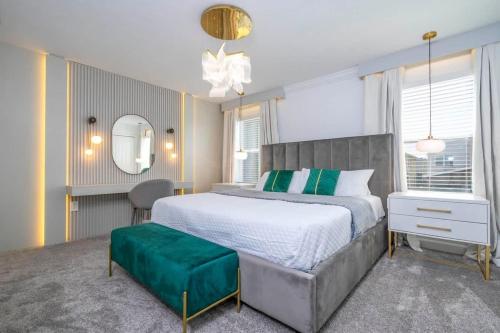 a bedroom with a large bed and a mirror at WonderFul 4Bd w Pool Close to Disney at StoreyLake 2669 in Kissimmee
