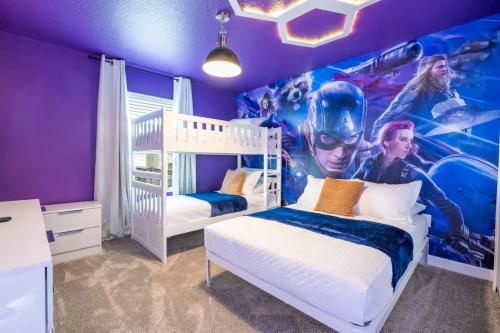 a bedroom with two beds and a movie mural at WonderFul 4Bd w Pool Close to Disney at StoreyLake 2669 in Kissimmee