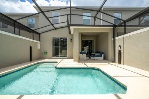 a swimming pool in the middle of a house at Fantastic 4 Bd w Pool at Storey Lake Resort 2709 in Kissimmee