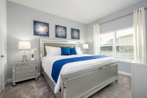 a bedroom with a large bed and a window at Fantastic 4 Bd w Pool at Storey Lake Resort 2709 in Kissimmee
