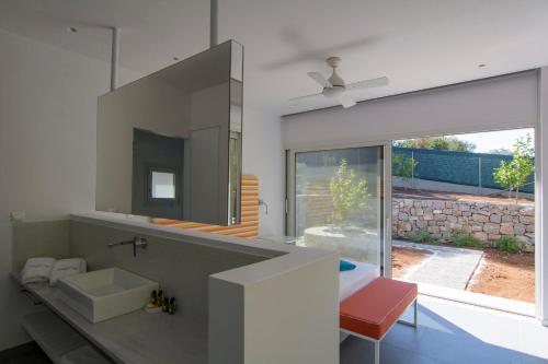 a bathroom with a sink and a mirror at Lavender Cove in Korfos