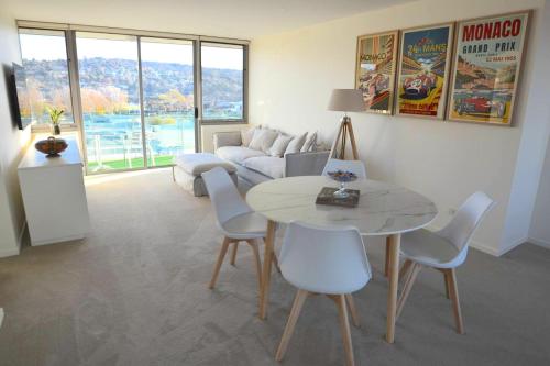 a living room with a table and chairs and a couch at Prime Luxury Penthouse Living in Launceston