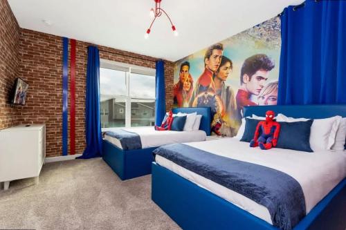 a bedroom with two beds with a superhero mural at Stunning Family Friendly 5 Bd w/ Pool Close to Disney @ Storey Lake 4242 in Kissimmee