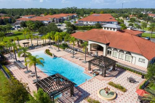 an aerial view of a pool at a resort at Four Bedroom w/ Screened Pool Close to Disney 4572 in Kissimmee