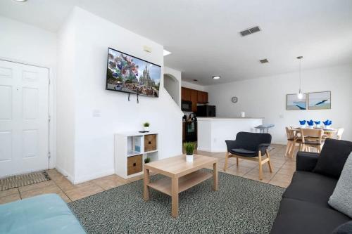a living room with a couch and a table at Four Bedroom w/ Screened Pool Close to Disney 4572 in Kissimmee