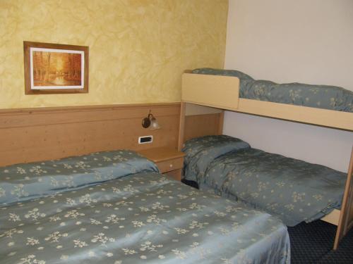 a room with two bunk beds and a picture on the wall at Villa Ilaria in Caderzone