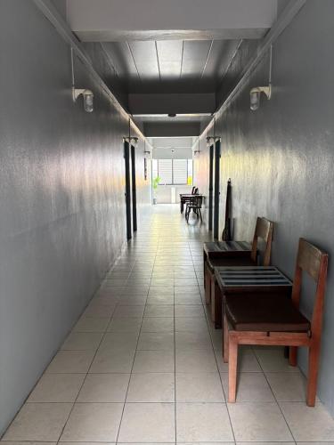a hallway with benches and tables in a building at BW Guesthouse in Ko Tao