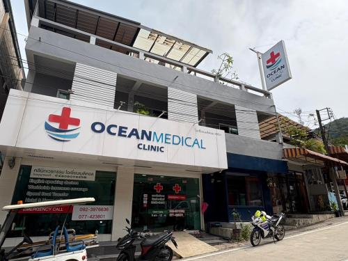 a building with a red and white sign on it at BW Guesthouse in Ko Tao
