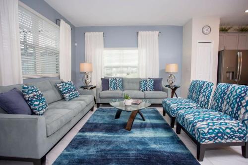 a living room with a couch and a table at Wonderful 5 Bedroom w/ Pool Close to Disney 4801 in Kissimmee