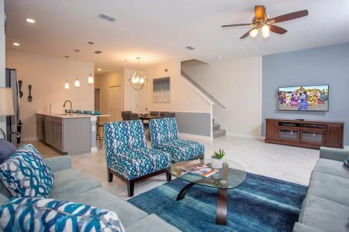 a living room with a couch and a table at Wonderful 5 Bedroom w/ Pool Close to Disney 4801 in Kissimmee