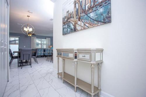 a dining room with a table and a painting on the wall at Wonderful 5 Bedroom w/ Pool Close to Disney 4801 in Kissimmee