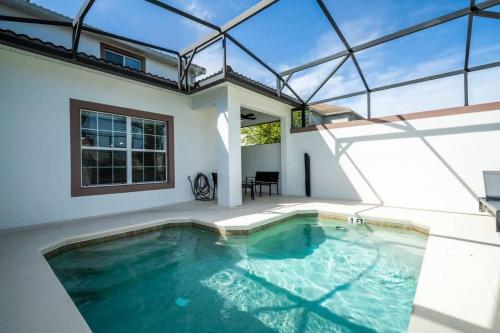 a swimming pool in a house with a glass ceiling at Five Bedrooms TownHome with Pool 4849 in Kissimmee