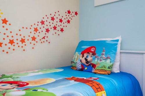 a childs bedroom with a mario clubhouse wall decal at Five Bedrooms TownHome with Pool 4849 in Kissimmee