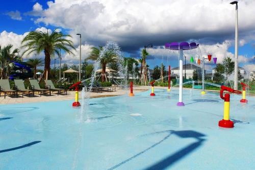 a pool with a water park with a water slide at Four Bedrooms close to Disney w Pool 4898 in Kissimmee