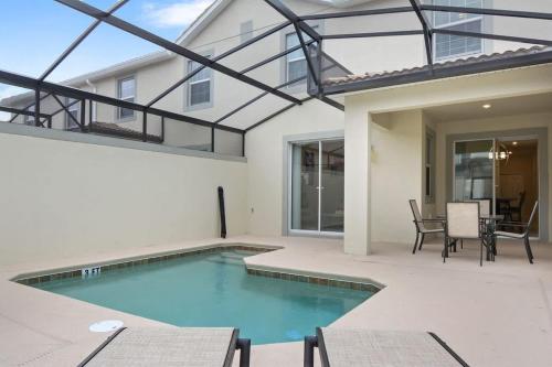 a swimming pool in the backyard of a house at Four Bedrooms close to Disney w Pool 4898 in Kissimmee