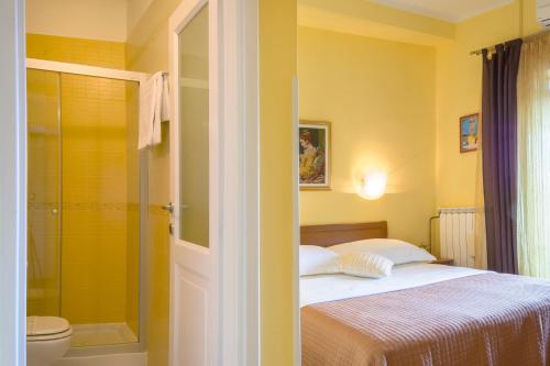 a bedroom with a bed and a shower and a toilet at Guesthouse Villa Marija in Motovun