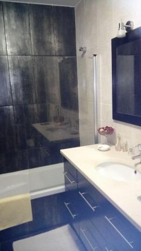 a bathroom with a shower and a sink and a tub at Porto's City Park & Surf Beach Rooms in Matosinhos